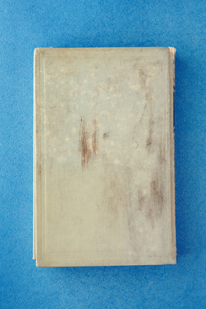 old dirty book on a blue background. Place for inscriptionの写真素材