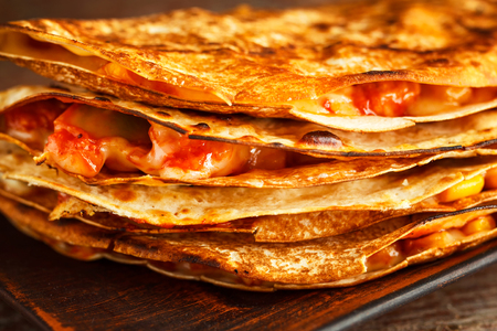 Mexican quesadilla closeup on a plate on a wooden table. Mexican fast foodの写真素材