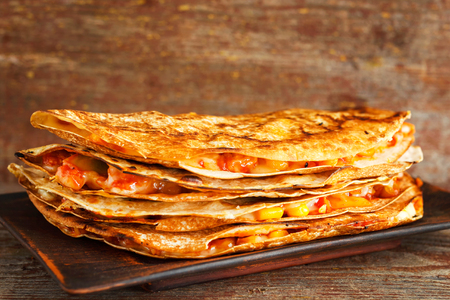 homemade quesadilla on a plate on a wooden table. Traditional Mexican cuisineの写真素材