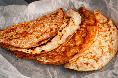 Home cooked Mexican quesadilla is stacked on a parchment. Mexican foodの写真素材