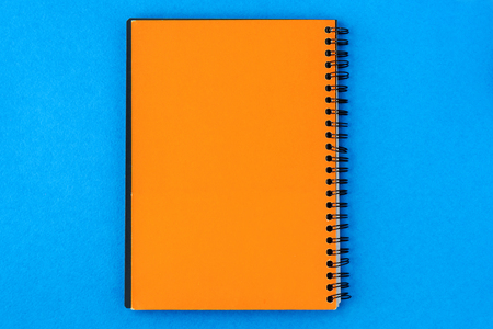 orange paper for notes in the center on a blue background.の写真素材