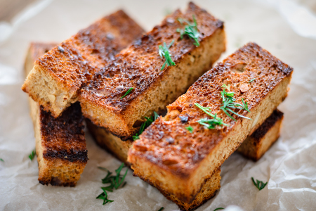 appetizing toasted toasts from rye bread with dill on white background. Close-upの写真素材