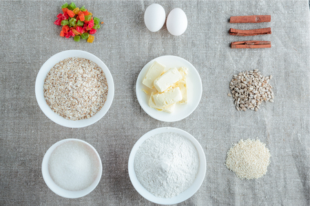 Ingredients for baking oatmeal cookies on a light background. Flat top imageの写真素材