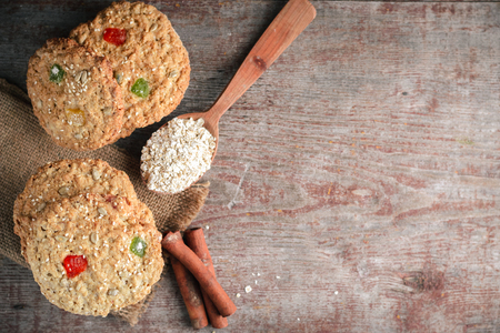 homemade oatmeal cookies, cinnamon sticks and oat flakes on a wooden table. Flat style, top view with copy spaceの写真素材
