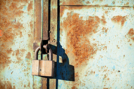 old iron barn castle on a metal rusty door in hard sunlight.  Access is deniedの写真素材