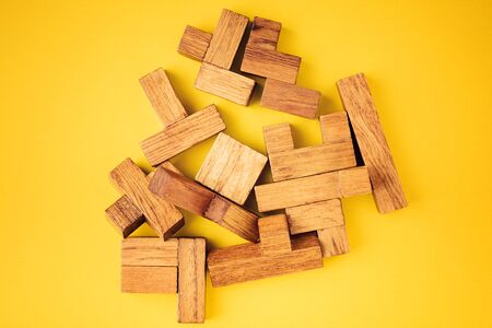 Abstract Background. Different shapes wooden blocks on yellow backgroundの写真素材