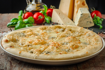 Pizza four cheese on the table whith ingredientsの写真素材