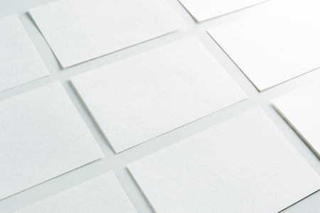 Mockup of horizontal business cards stacks arranged in rows at white background.の写真素材