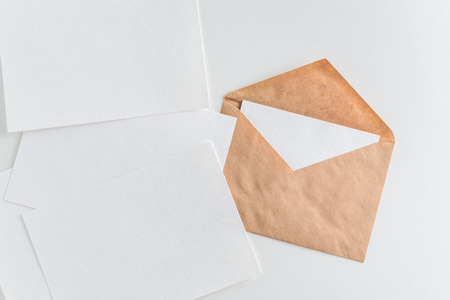 Mockup of craft envelope and blank white paper on white backgroundの写真素材
