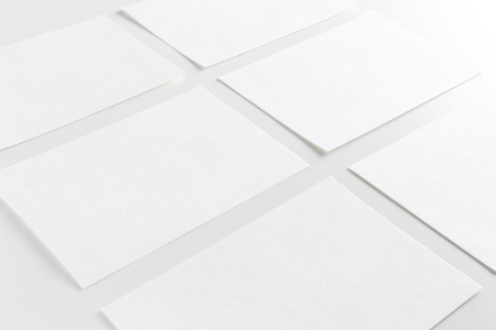 Mock up of white paper business cards in row on white backgroundの写真素材