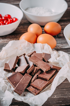 ingredients for chocolate cake brauni on black wooden background. Vertical compositionの写真素材