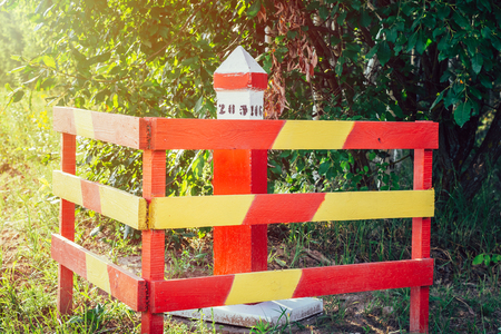 Red and yellow quarter post sign in summer forest close upの写真素材