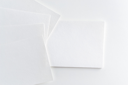 Mockup of business cards stack at white textured paper backgroundの写真素材