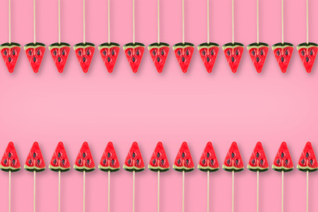 pattern of candy in shape of watermelon on pink background, flat layの写真素材