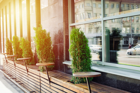 Street view on empty chairs of coffee terrace with sunlightの写真素材
