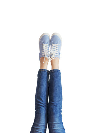 Woman legs in blue jeans on white background isolatedの写真素材