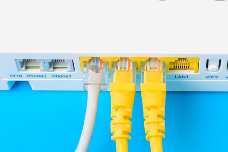 internet modem router hub with cable connecting on blue background