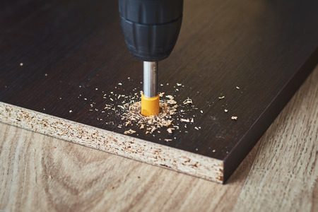 process of drillig wood with drill bit close upの写真素材