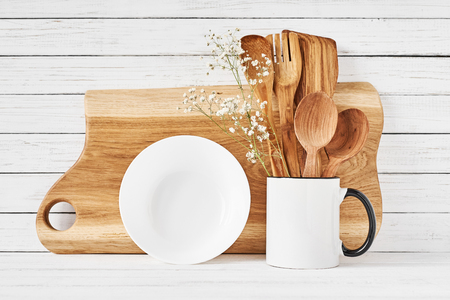 Kitchen tools and cutting board on white table. Kitchen utensils backgroundの写真素材