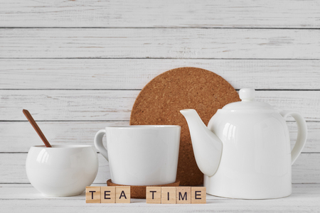 Cup of tea, teapot and sugar bowl on white backgroundの写真素材