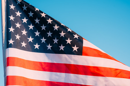 American flag in blue sky. close up. Symbol of Independence Day fourth of July in USAの写真素材