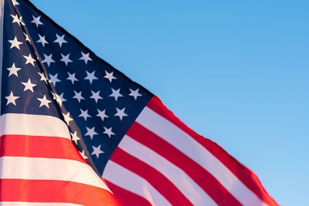American flag in blue sky. close up. Symbol of Independence Day fourth of July in USA