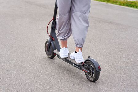 Close up of man driving on electric scooter in cityの写真素材