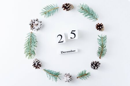 Christmas decorations round frame made of pine cones and fir tree branches on white background, top...
