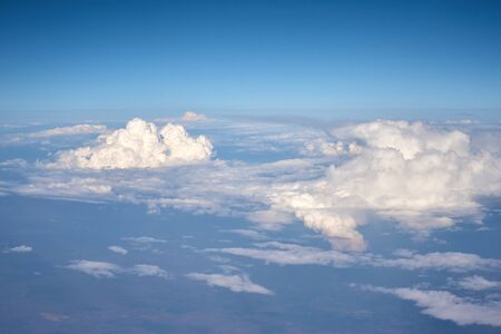 Aerial view of fluffy clouds. Top view of beautiful cloudscape and blue sky