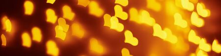 Abstract background with golden blurred lights in heart shape. Valentine day conceptの写真素材