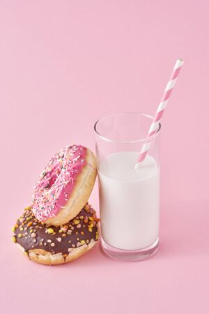 Donuts with glass of milk on pink backgroundの写真素材