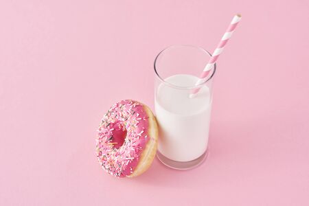 Donuts with glass of milk on pink backgroundの写真素材