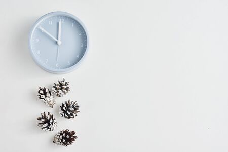 Alarm clock with pine cones on white background, top view. Minimal creativity flat lay styleの写真素材