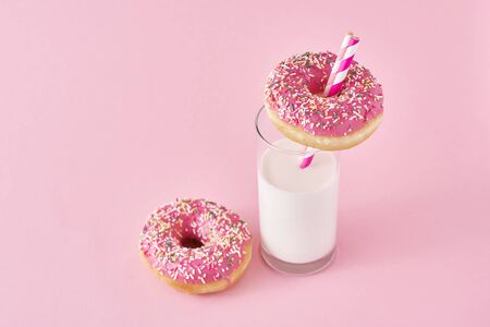 Donuts with glass of milk on pink backgroundの写真素材
