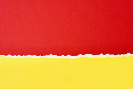 Torn ripped paper edge with copy space, red and yellow color backgroundの写真素材