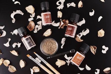 Dobrush, Belarus - October 27, 2019: natural henna powder in bottles and eyelash brush on dark backgroundのeditorial素材