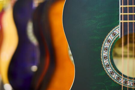 Row of classic acoustic guitars in the store
