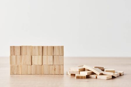 Wall made of wooden blocks on white background. Finishing task concept