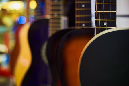 Row of classic acoustic guitars in the store