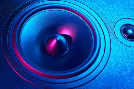 Sound audio speaker with neon lights on dark background. Dynamic monitor closeup. Creative backgrooundの写真素材