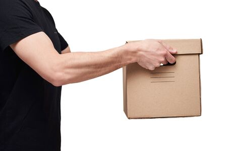Delivery man in black t-shirt hold cardboard box on white isolated background. Delivery service...