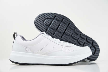 Pair of white male sneakers on a white background isolated. Fashion stylish sport shoes, close up