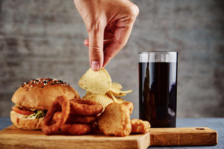 Unhealthy and junk food. Different types of fast food on the table, close up