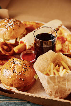 Unhealthy and junk food. Different types of fast food on the table, close up