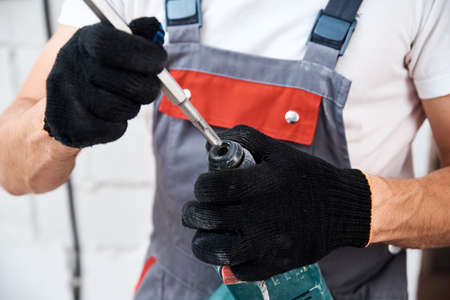 Man worker using hammer drill, close upの写真素材