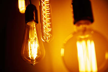Set of vintage light bulb on orange background, soft focus. Glowing edison bulb