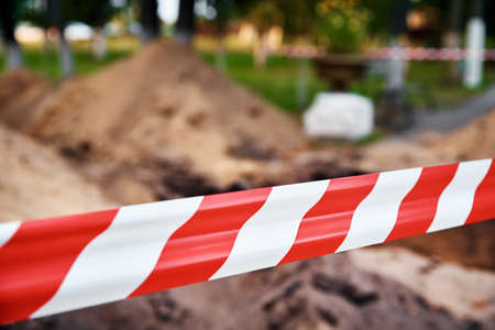 Red and white barrier tape protect a danger place