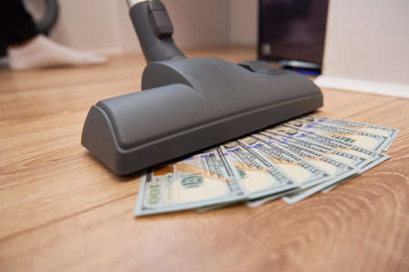 Vacuum cleaner sucks usd dollar banknotes. Launder money conceptの写真素材