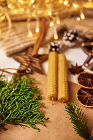 Composition with a christmas decorations, candles and garland lights. Hugge mood background