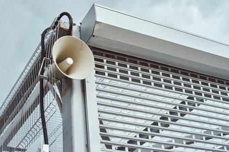 Public megaphone on building construction. Speaker for announcing outdoorの写真素材